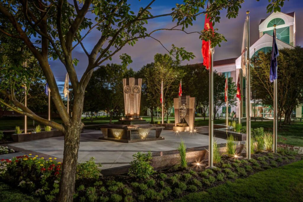 A military memorial featuring beautifully illuminated monuments and flags. 