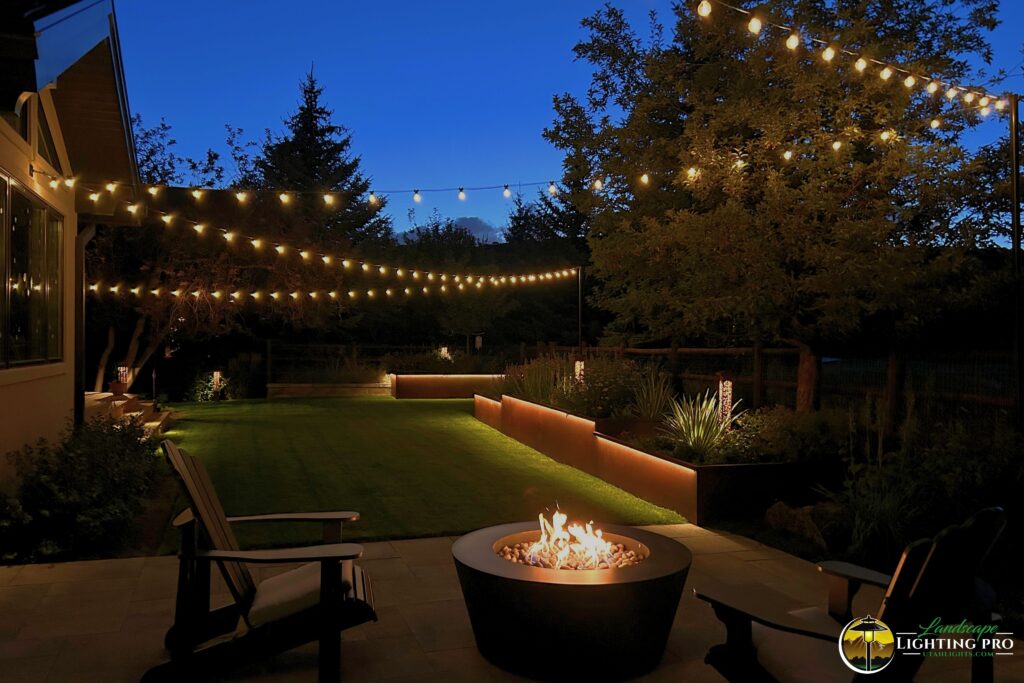 backyard with bistro lighting hanging above the space