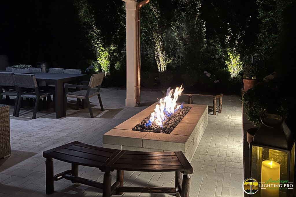 outdoor fireplace illuminated by downlight 